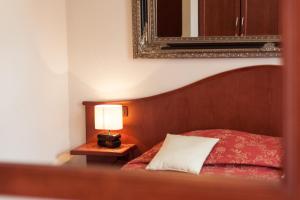 
a bedroom with a bed and a lamp at Hotel Domino in Zagreb
