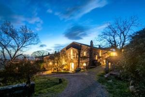 a large stone house with a driveway at Pieve di Caminino Historic Farm in Podere Caminino