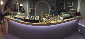 a counter with many different types of food on it at Hôtel des Rochers in Perros-Guirec