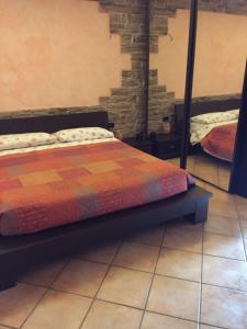 a bed sitting on a tiled floor in a room at Comfort in Scandicci
