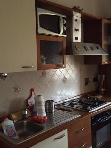 a kitchen with a sink and a stove top oven at Comfort in Scandicci