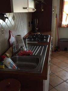 a kitchen with a sink and a stove at Comfort in Scandicci