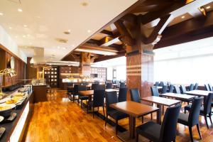 a restaurant with wooden tables and chairs and a bar at Sapporo Excel Hotel Tokyu in Sapporo