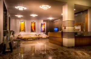 a lobby with a couch and a television in it at Hotel Sea N Rock in Thane