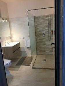 a bathroom with a shower and a toilet and a sink at Camere Mazara in Mazara del Vallo