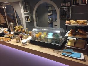 a bakery counter with bread and pastries on it at Hôtel des Rochers in Perros-Guirec