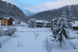 a village covered in snow with houses and trees at Maison Perron CIR- VDA-LATHUILE-N0062 in La Thuile