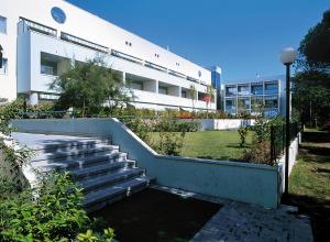 a building with stairs in front of a building at Apartment Pine Wood in Bibione
