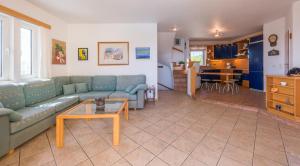 a living room with a couch and a table at Villa Adamite in Sounio