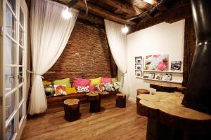 a living room with a couch and a brick wall at Pensión Basque Boutique in Bilbao