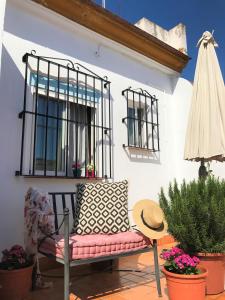 a chair on a patio with a table and a window at Casa Antón in Seville