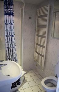 a bathroom with a sink and a toilet at City Apartments Antwerpen in Antwerp +61 photos