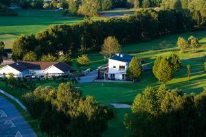 RisekatslösaSöderåsens Golf Lodge的高尔夫球场上房子的空中景观