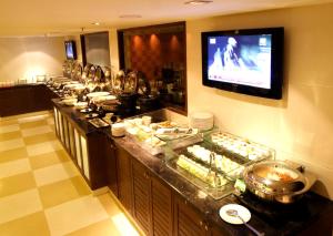 a buffet line of food in a hotel room at Aditya Hometel in Hyderabad