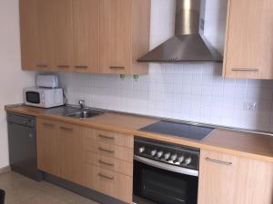a kitchen with a sink and a stove top oven at Apartamento Atlántico in Vecindario
