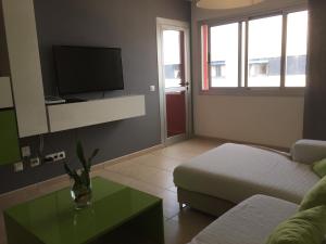 a living room with a couch and a tv at Apartamento Atlántico in Vecindario