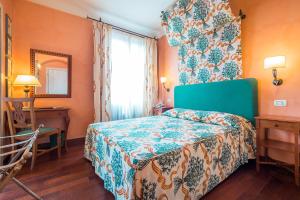 Postel nebo postele na pokoji v ubytování Hotel Vecchio Borgo