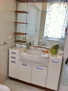 La salle de bains est pourvue d'un lavabo et d'un miroir. dans l'établissement silvia' s house, à La Spezia