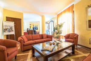 a living room with couches and a coffee table at Hotel Vecchio Borgo in Palermo