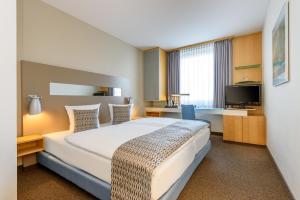 Postel nebo postele na pokoji v ubytování Mercure Hotel Düsseldorf City Nord
