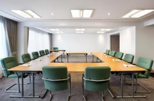 a conference room with a long table and chairs at Jurys Inn Aberdeen Airport in Dyce