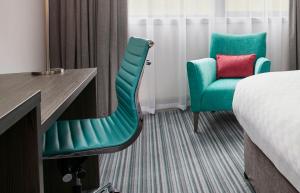 a hotel room with a bed and a desk and a chair at Jurys Inn Aberdeen Airport in Dyce