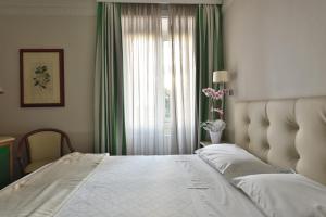 Postel nebo postele na pokoji v ubytování Lolli Palace Hotel