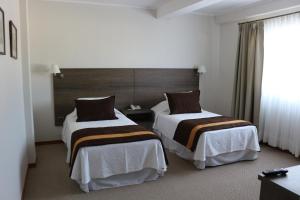 Postel nebo postele na pokoji v ubytování Conrado Hotel Osorno + 37 fotografií