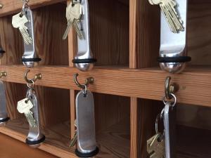 a bunch of keys hanging on a shelf at THEODORS Boutique Hotel in Wustrau