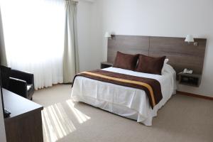 Postel nebo postele na pokoji v ubytování Conrado Hotel Osorno