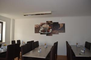 a dining room with tables and chairs and a cup of coffee at B&D Hotel in Hannover