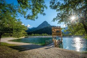 a view of a lake with a mountain in the background at Apartments Smolej Kranjska Gora in Kranjska Gora