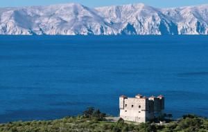 a castle in the middle of a large body of water at Guesthouse Vesna in Senj
