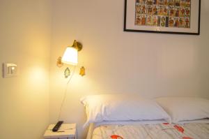 a bedroom with a bed and a lamp on a night stand at La Chiromante in Naples