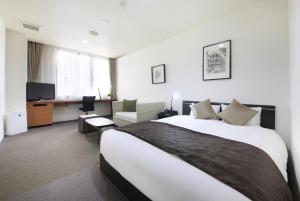Postel nebo postele na pokoji v ubytování Hotel Tohkai
