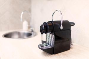 a tie holder sitting on a counter next to a sink at Tritone 91 Apartments in Rome +40 photos