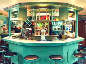 a bar in a restaurant with stools around it at Hotel ABA in Novokuznetsk