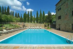 a swimming pool with a pool table and chairs at Villa Schiatti in Cortona