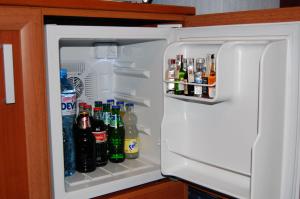 an open refrigerator filled with lots of drinks at Hotel Kibella in Sofia