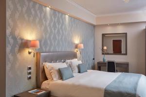 Voodi või voodid majutusasutuse Ava Hotel and Suites toas