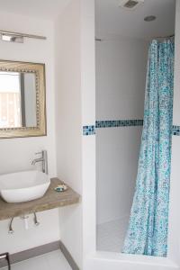 a bathroom with a sink and a shower at Bellevue Suites in Buckleys