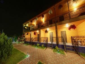 a building with lights on the side of it at night at Hotel-complex Mizh Triokh Ozer in Svityazʼ