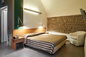 Säng eller sängar i ett rum på San Rocco Hotel