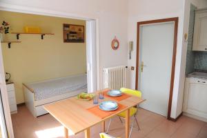 a small kitchen with a table and a bed at Residence Il Sole in Follonica +19 photos