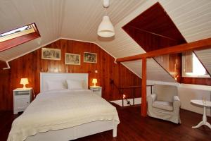a bedroom with a bed and a chair in a attic at Duplex Lisbon Castle Sao Jorge in Lisbon