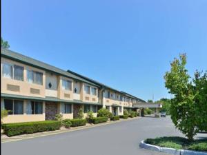 a large building with a road in front of it at Americas Best Value Inn New Paltz in New Paltz