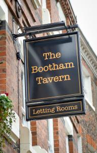 a sign for the bathroom tavern on a building at The Bootham Tavern - York in York