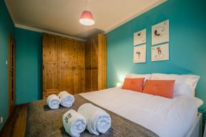 a bedroom with a large bed with towels on it at MOMOApart - by Kromera in Wrocław