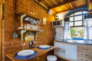 a kitchen with a wooden counter with plates on it at Vila Báltica Chalés in Campos do Jordão