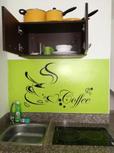 a kitchen sink with the words coffee written on it at Francisco Habitaciones in Manta